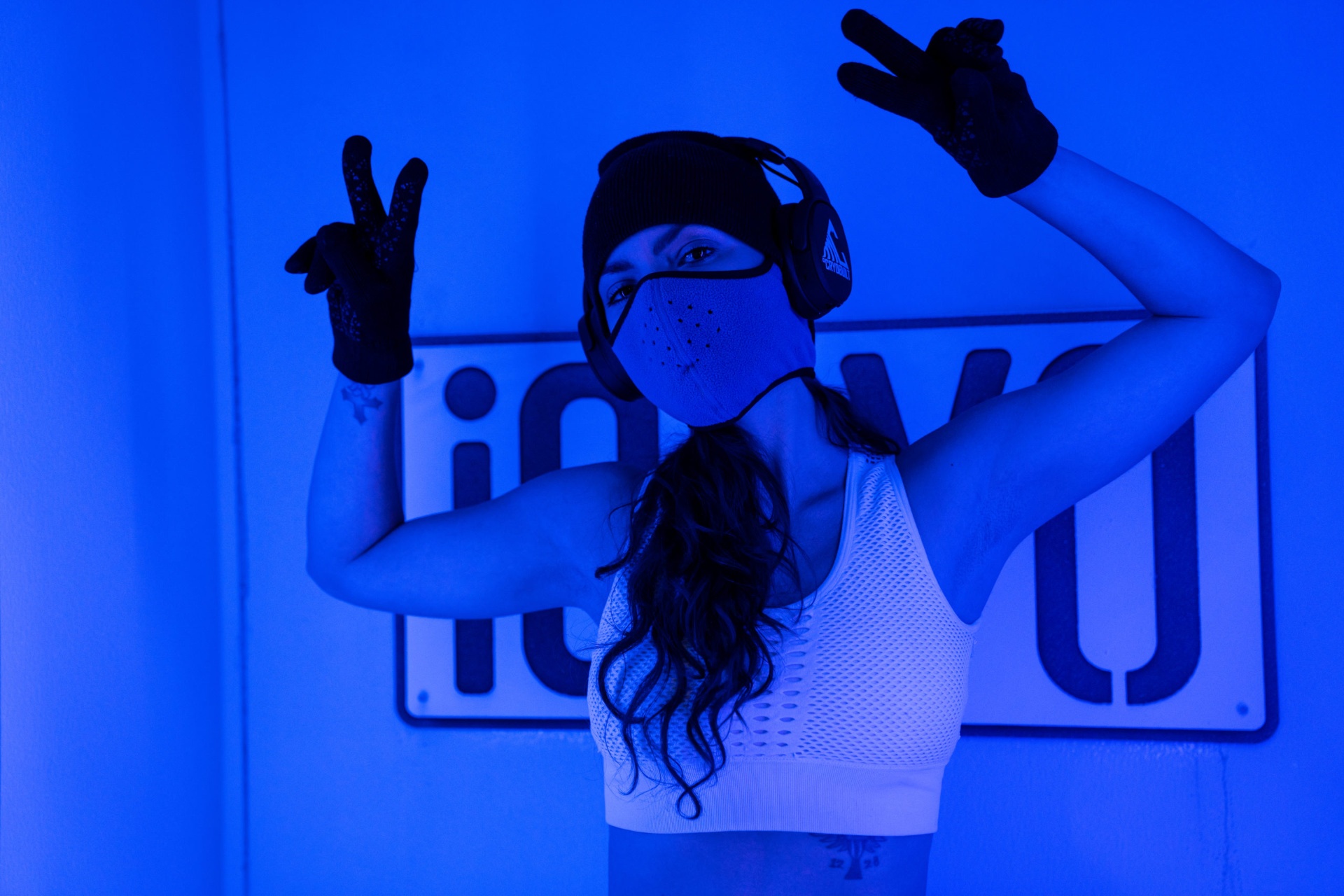 Client stepping into a whole body cryotherapy chamber at iCRYO Highland Village