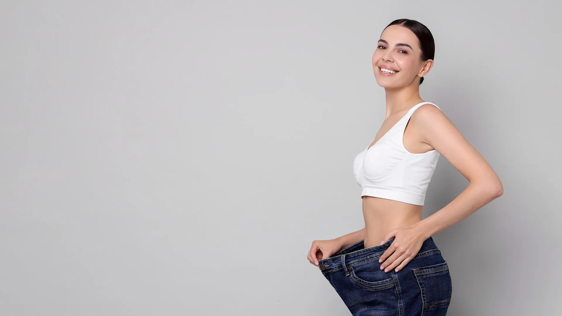 Woman celebrating weight loss results at iCRYO Highland Village Medical Weight Loss program